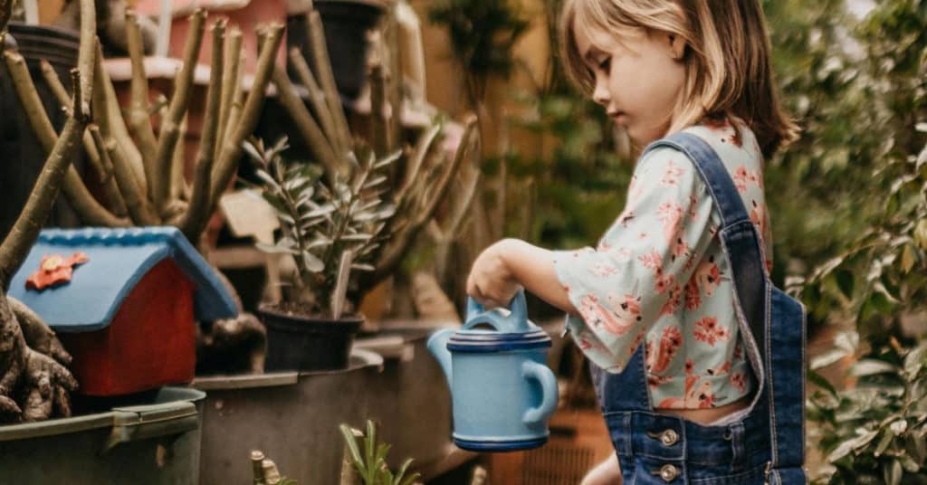 Ethical Brand Directory Blog | Top 10 Tips for Going Green | Little girl watering plants