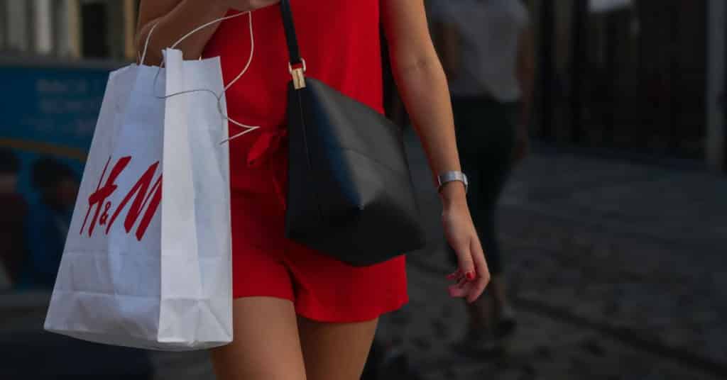 Ethical Brand Directory Blog | Conscious Shopping: How Small Changes Can Make a Big Difference | Woman with fast fashion shopping bag
