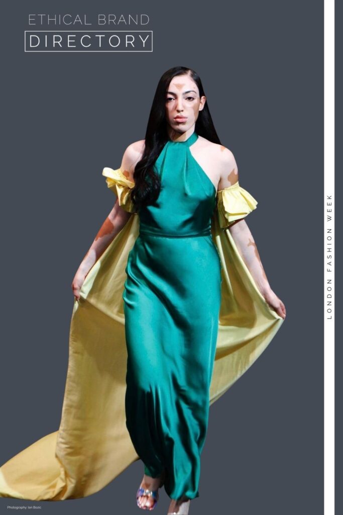 Jasroop  from Zebedee wearing a green evening dress with a yellow cape by Sanyukta Shrestha, Styled by Roberta Lee for London Fashion Week. 
