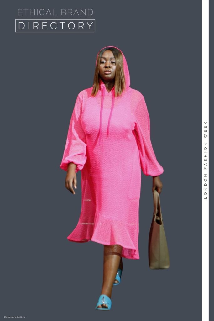 Nadia wearing a pink hooded dress by Sylvia Piechulla, carrying a reversible vegan tote bag by The Morphbag.